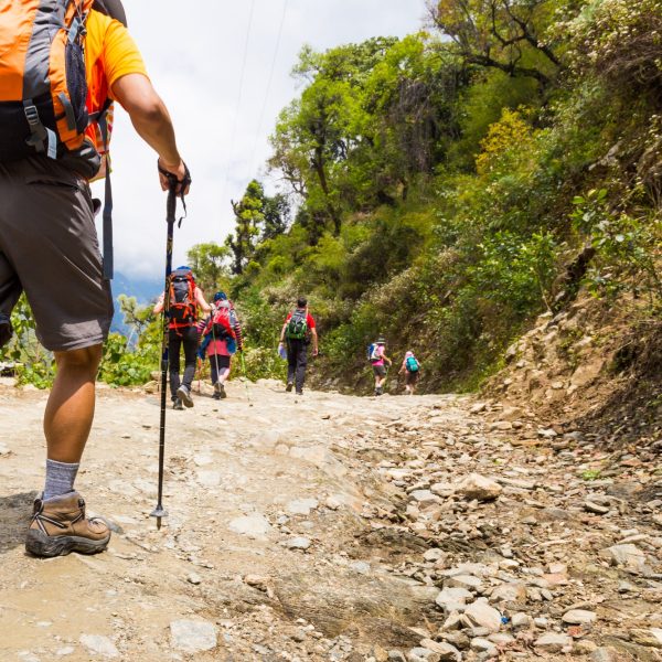 A group of people trekking on dirt road in Nepal